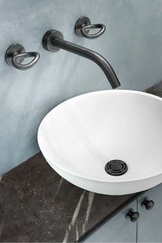 a white bowl sink sitting on top of a counter