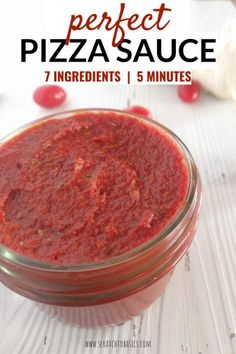 a jar filled with red sauce sitting on top of a table