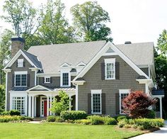 a gray house with white trim and windows