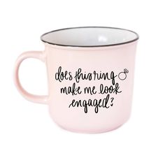 a pink coffee mug with the words does having make me look engaged?