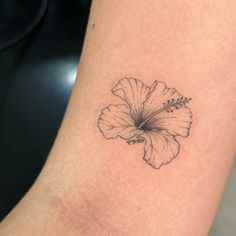 a small flower tattoo on the ankle