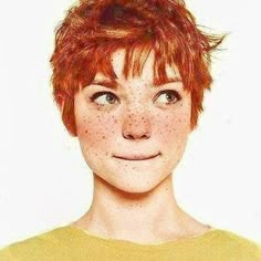 a woman with freckles on her face looking at the camera