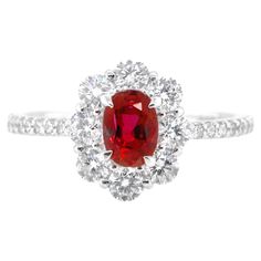 A beautiful ring set in Platinum featuring a GIA Certified 0.85 Carat Natural Thailand Ruby and 0.74 Carat Diamonds. Rubies are referred to as "Ratnaraj" in Sanskrit meaning the King of Gems. Early cultures treasured rubies for their similarity to the redness of the blood that flowed through their veins, and believed that rubies held the power of life. The ring is made in Japan. Ring size and stamping detailed below. Contact Us for more information. If required, we can adjust the ring size free Dazzling Gia Certified Ruby Ring, Classic Cluster Ruby Ring With Center Stone, Classic Ruby Cluster Ring With Center Stone, Classic Red Cluster Diamond Ring, Exquisite Gia Certified Cluster Ring, Dazzling Ruby Anniversary Ring, Gia Certified Dazzling Ruby Ring, Dazzling Gia Certified Ruby Ring As Gift, Red Cluster Rings With Brilliant Cut