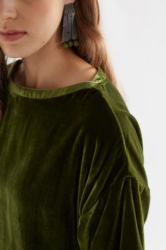 Product Details Velvet top. The Suuri Velvet Top is a simple velvet top featuring a boxy sleeve with a dropped shoulder designed to hit above the elbow. The top has a slight boat neck with a neckband wrap detail at either side. With a curved hem, this top has a longer body length. The low-pile velvet has an elegant drape and a subtle sheen. Boxy sleeve Dropped shoulder Slight boat neck Neckband wrap detail Curved hem Velvet fabric has drape and slight sheen Material 74% Viscose 26% Nylon A luxur Green Velvet Shirt, Australian Dresses, Velvet Shirt, Velvet Tops, Lifestyle Clothing, Plus Size Womens Clothing, Plus Size Tops, Jacket Tops, Dress Collection