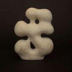 a white sculpture sitting on top of a black table