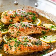 chicken with lemons and herbs in a pan