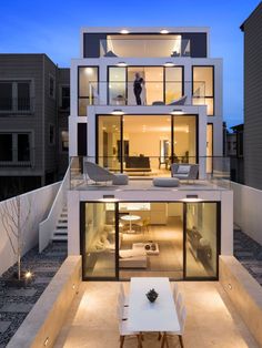 a modern house is lit up at night