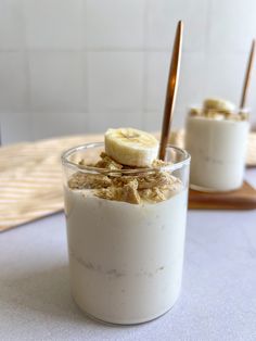 two glasses filled with food on top of a table