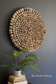 a plant is sitting on top of a table next to a wall decoration with wooden circles