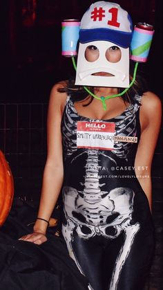 a woman wearing a skeleton costume with a helmet on her head