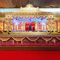 a man and woman standing in front of a stage set up for a wedding ceremony