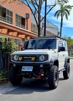 a white four door suv parked on the street