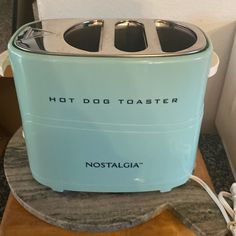 a toaster with the words hot dog toaster on it sitting on a table