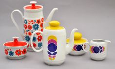 a group of teapots and cups sitting next to each other