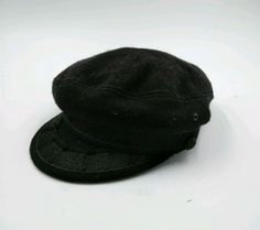 a black hat sitting on top of a white table