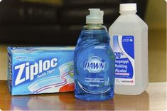 two bottles of mouthwash sitting on top of a table next to a box of tissues