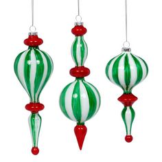 three green and white striped ornaments hanging from strings with red accents on the top, bottom and bottom