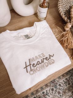 Embroidered Make Heaven Crowded Tshirt Sizing: Unisex (see size guide in photos for measurements) Color: White Thread Color: ivory & beige Material: 100% Cotton Brand: Comfort Colors  *cannot be personalized or have default embroidery changed* PROCESSING/TURNAROUND TIME: -Processing/Turn around times may vary. Please check the estimated ship/delivery times.  -Processing/Turn around time DOES NOT include shipping time. Christian Shirt Embroidery, Christian Embroidery Tshirt, Aesthetic Christian Clothes, Embroidery Christian Designs, Cool Shirt Ideas, Embroidery Designs For Shirts, Embroidery Shirt Designs, Embroidered Tshirts, Jesus Embroidery