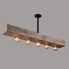 a wooden beam with five light bulbs hanging from it