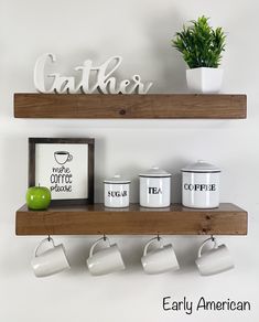 two wooden shelves with coffee mugs and an apple on one shelf next to the other