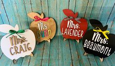 three wooden apple shaped magnets with the words mrs and mr's on them