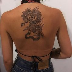 a woman with a dragon tattoo on her back