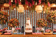 a table topped with lots of different types of cakes and desserts covered in flowers