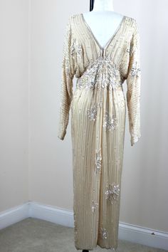 "I absolutely love this dress, I have seen some different colors and similar style and I absolutely love it. It is so 1930s. There are amazing sequin beaded designs on it and silver beads and sequins throughout. An absolutely beautiful gown!! This is in Very good to Excellent condition!! A true beauty!! Measuring; 56\" length Bust: 40\" (this is blouson, it is actually a bit larger as it is a blouson style Waist: 26\" Hip\" 40\" Sleeves: 25\" This definately is not a stretchy style dress, it is Art Deco Evening Dress With Sequins, Art Deco Sequin Evening Dress, Embellished Floor-length Vintage Evening Dress, Vintage Sequin Evening Gown, Vintage Embellished Evening Dress, Glamorous Sequined Dress For Vintage Events, Elegant Beaded Dresses For Vintage Events, Vintage Sequin Gown For Evening, Art Deco Embellished Dresses For Vintage Style