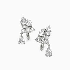 These extraordinary earrings exhibit glittering round-cut accents arranged in a cluster pattern, highlighting pear-cut stones held elegantly in the center. Gleaming with these earrings, your ensembles are sure to be elegant and charming.Carat Weight: 1.86 ctStone Size: 3*5,2.5*4,2,3,2.5 mmStone Type: Moissanite/GemstoneNumber of Stones: 18 Stone Shape: Pear, RoundStone Color: OptionalWidth: 8.5 mmHeight: 16 mmThickness: 8 mmMaterial: 10K/14K/18K Solid Gold , Platinum Sparkling Cluster Earrings For Formal Occasions, Luxury Cluster Earrings For Wedding, Formal Sparkling Diamond White Cluster Earrings, Formal Fine Jewelry Cluster Earrings With Sparkling Stones, Luxury Clip-on Cluster Earrings For Wedding, Elegant Cluster Earrings With Sparkling Details, Cluster Earrings With Sparkling Stones For Wedding, Gold Platinum, Pear Cut