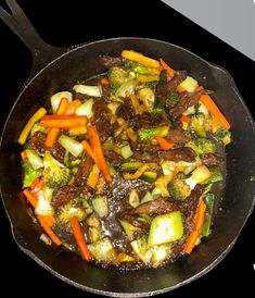 a stir fry with vegetables being cooked in a wok