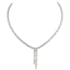 Exquisite diamond bow motif drop necklace, by Alexander Beverly Hills. 25.09 carats total diamond weight. 50 oval brilliant diamonds, 15.74 carats. 50 round brilliant diamonds, 9.35 carats. Approximately G-I color and VS1-SI1 clarity. Prong set in 18k white gold, 33.13 grams, and 16-17 inches. Accommodated with an up-to-date digital appraisal by a GIA G.G. once purchased, upon request. Please contact us with any questions. Item Number N6714 Diamond Bows, Tennis Necklace, Diamond Drops, Drop Necklace, Brilliant Diamond, Item Number, Round Brilliant, Round Diamond, Beverly Hills