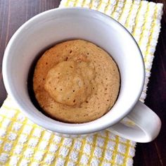 a cookie in a white bowl on a yellow and white towel