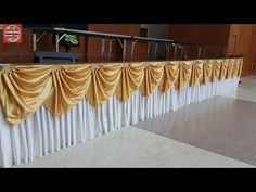 a long table with gold drapes on it