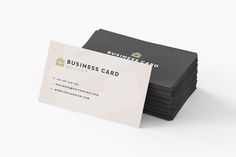 a stack of business cards sitting next to each other on top of a white surface