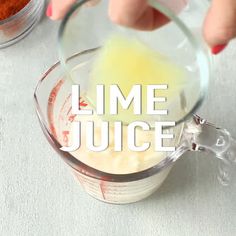 someone mixing ingredients in a blender with the words lime juice