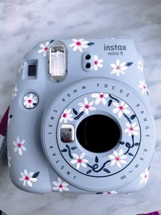 an instax camera sitting on top of a table