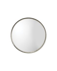 a round mirror on a white wall