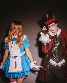 two people dressed in costumes standing next to each other