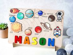 a wooden sign with magnets on it that says mason