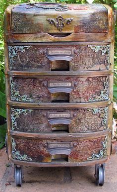 an old wooden dresser with many drawers in the middle of some bushes and trees behind it