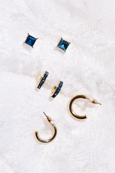 The dreamiest navy blue earrings are here! This set of 3 pairs of earrings features post-back, navy jewel stud earrings, hinge-back, navy jewel detailed huggie hoops and post-back, gold small hoops. All three pairs are lead, nickel, and cadmium free. Navy Jewelry, Dark Blue Earrings, Navy Earrings, Navy Blue Earrings, Ivy City Co, Winter Dance, Dazzling Earrings, Huggie Earring, Vintage Hair Accessories