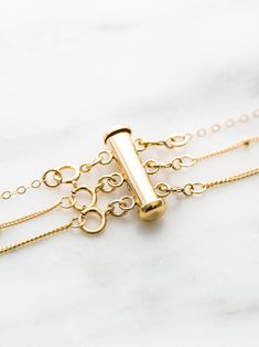 The solution to your tangled layering necklaces - our layered necklace detangler! Wear up to 4 necklaces without worrying about tangles. 14k gold fill & sterling silver are durable materials for everyday wear, meaning you can shower and work out in it. Adjustable Gold Plated Jewelry With Spring Ring Clasp, Dainty Gold Necklace With Extender, Adjustable 14k Gold Charm Necklace, Dainty Everyday Necklace With Extender, 14k Gold Adjustable Chain Charm Necklace, 14k Gold Charm Necklace With Adjustable Chain, 14k Gold Adjustable Charm Necklace, Adjustable Jewelry With Lobster Clasp For Layering, Adjustable Double Strand Gold Charm Necklaces