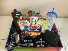 a box filled with lots of different types of candy and snacks on top of a table