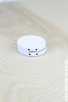 a white object sitting on top of a wooden table