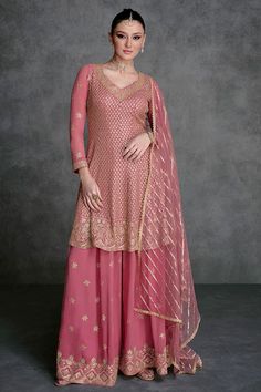 This Rose Pink Embroidered Georgette Sharara Suit showcases impeccable artistry. The anarkali top is embellished with intricate sequins, beads, and resham zari work embroidery. It comes with a heavily adorned georgette sharara bottom, featuring a four-sided lace border and a delicate net dupatta with sequins. Final Sale Fabric: Georgette Work: Embroidered Top Length: 36" Bottom Length: 40" Long sleeves 20" Elastic waist band Shape: Anarkali Lining on top & bottom Occasion: Party Wear, Wedding We Embroidery Kameez, Designer Sharara Suits, Anarkali Tops, Sharara Suits, Pakistani Style, Zari Embroidery, Kurta Dress, Sharara Suit, Party Wear Lehenga