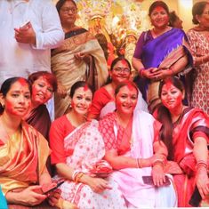 a group of people that are posing for a picture with their faces painted red and yellow