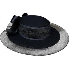 This elegant vintage black wide-brim hat features a stunning satin and mesh bow with a dramatic floral accent, making it the perfect statement piece for formal events or special occasions. The hat boasts a classic, sophisticated design with a 4.5" brim and measures 22" around, ensuring a comfortable fit. Whether for church, weddings, or garden parties, this timeless accessory will elevate your ensemble. Brand: Unbranded Size: Medium (22" around) Measurements: 7.5" across, 4.5" brim Condition: Excellent vintage condition Keywords: vintage wide brim hat, black formal hat, satin and mesh bow, floral accent hat, church hat, garden party hat, statement hat, vintage millinery, elegant headwear, 22 inch hat, medium hat, women's formal accessories, retro style hat, vintage fashion, classic black h Black Wide Brim Hat, Formal Hat, Statement Hat, Church Weddings, Mesh Bows, Church Hat, Formal Accessories, Vintage Millinery, Elegant Hats