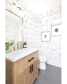 a bathroom with white tile and wood accents on the walls, along with a wooden cabinet