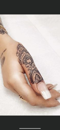 a woman's hand with tattoos on it