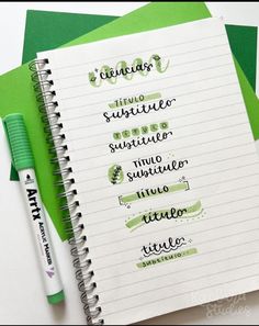 a notepad with writing on it next to a green pen and some other items